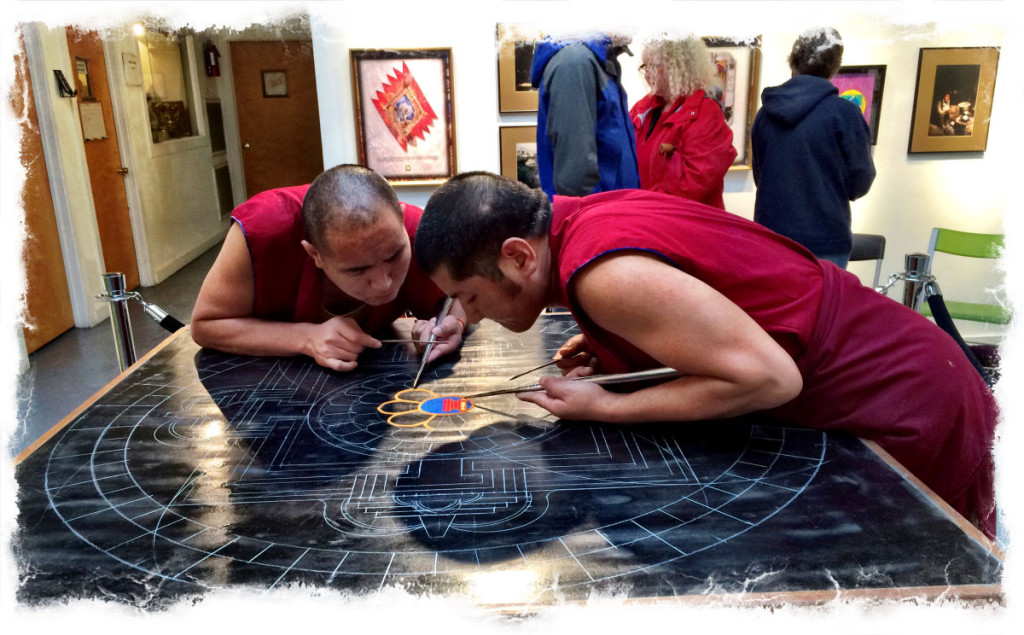 The first grains of sands are placed in the center of the mandala.
