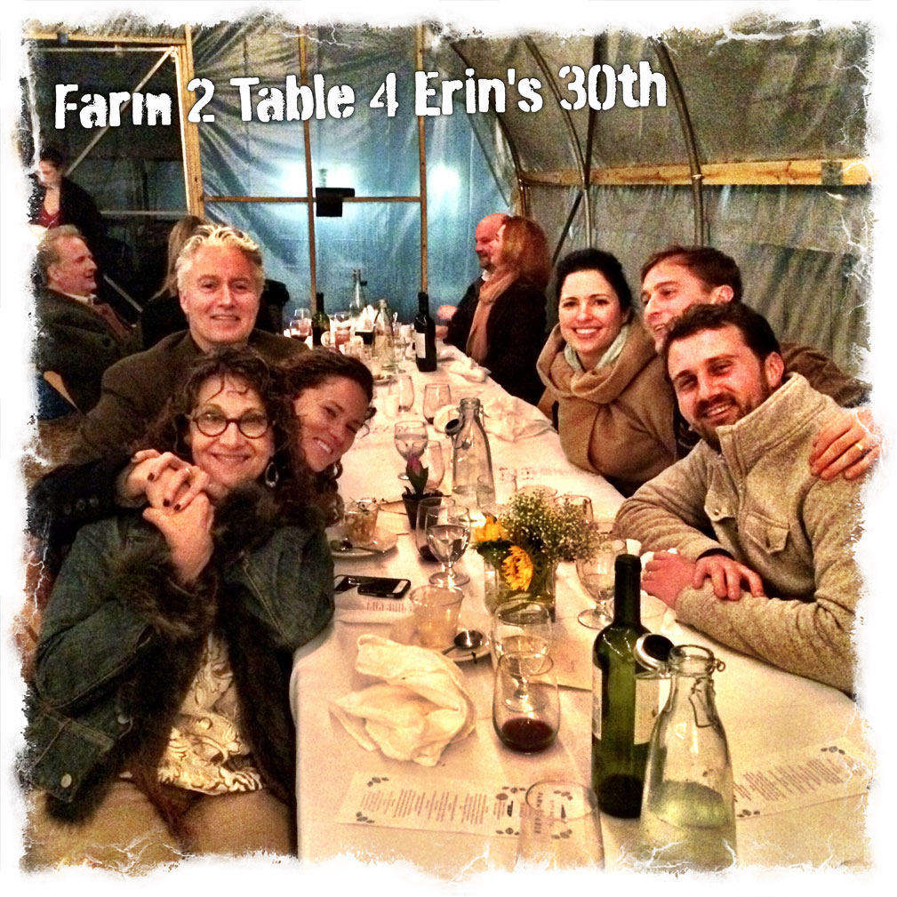 Group of people around a table with food and drinks